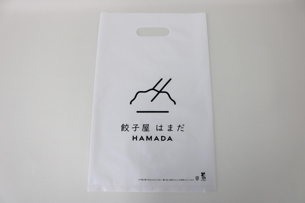 バイオマス25%LDPE(乳白)0.08㎜のグラビア印刷片面1色の小判穴抜きポリ袋の表面画像